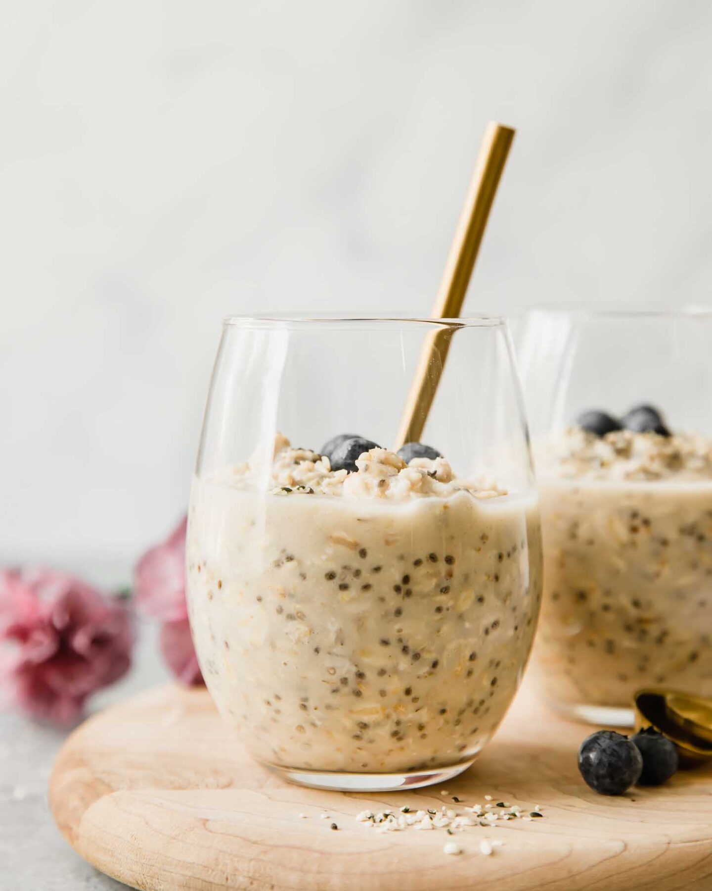 Vanilla Cream Protein Overnight Oats in a glass cup with a spoon.