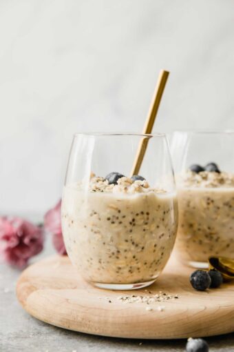 Vanilla Cream Protein Overnight Oats in a glass cup with a spoon.