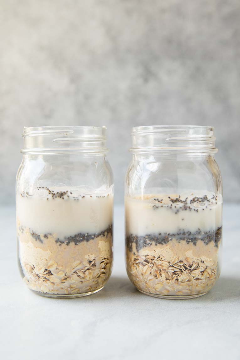 Ingredients being mixed together for overnight oats in a jar.