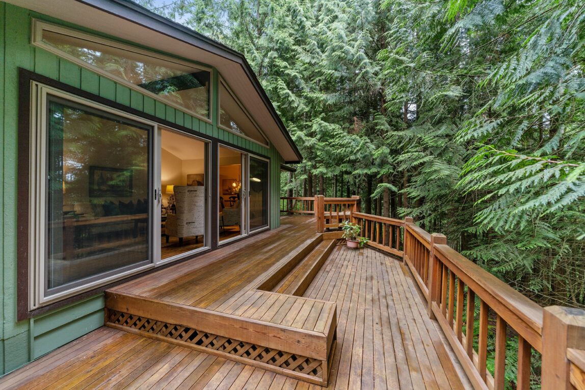 A house with a large wooden deck.