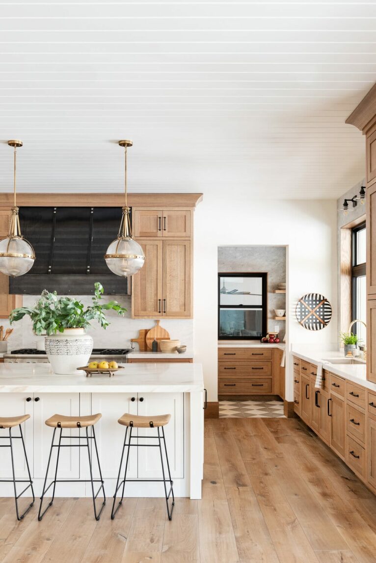 Warm wood kitchen with big windows.
