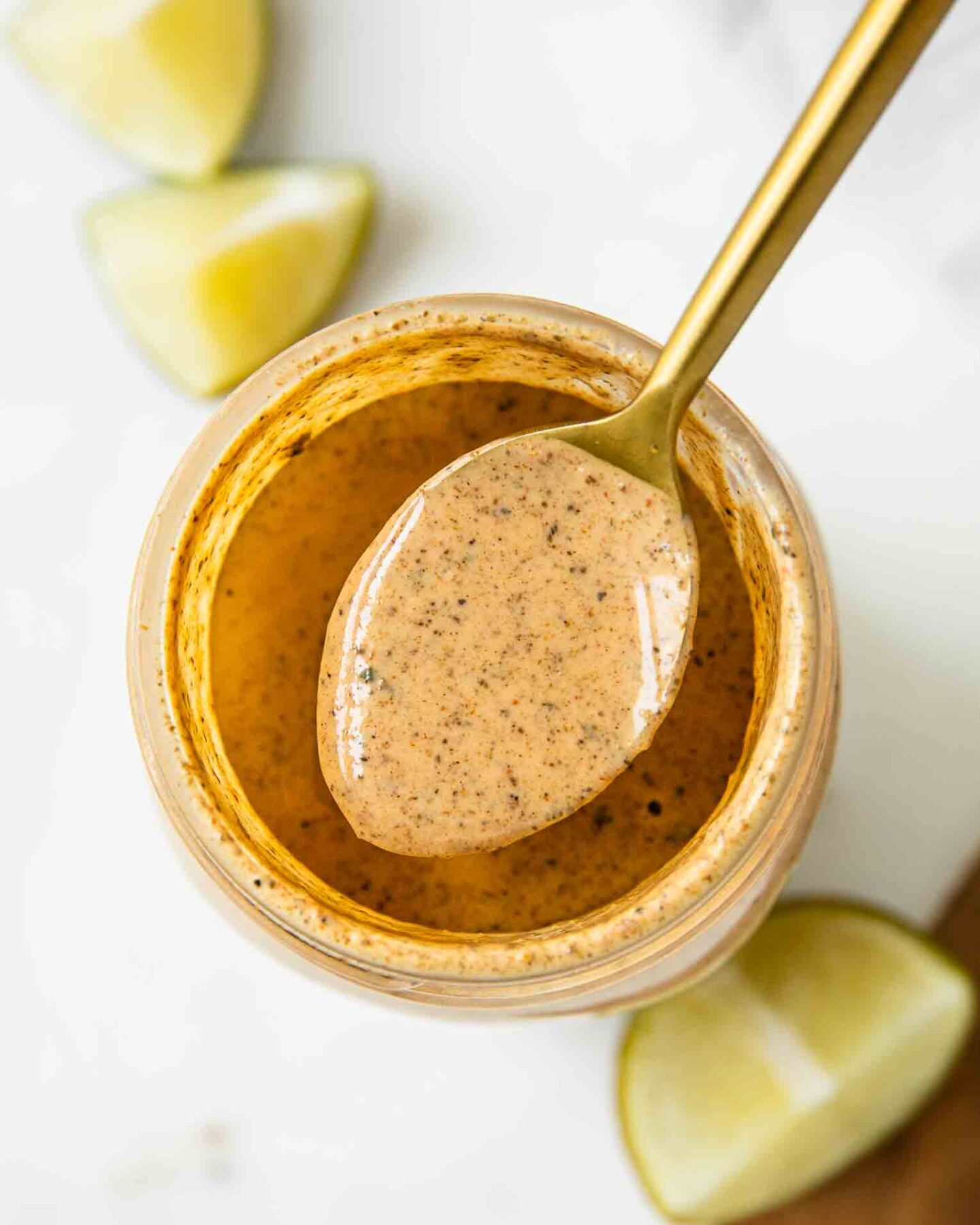 Top shot of southwest salad dressing in a jar with a spoon.