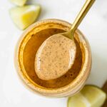 Top shot of southwest salad dressing in a jar with a spoon.