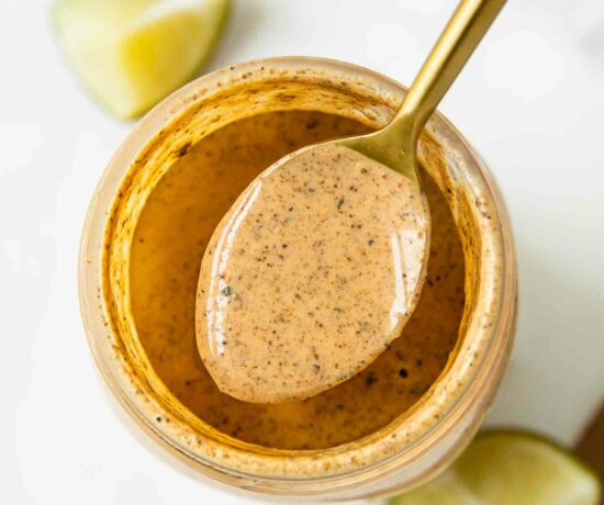 Top shot of southwest salad dressing in a jar with a spoon.