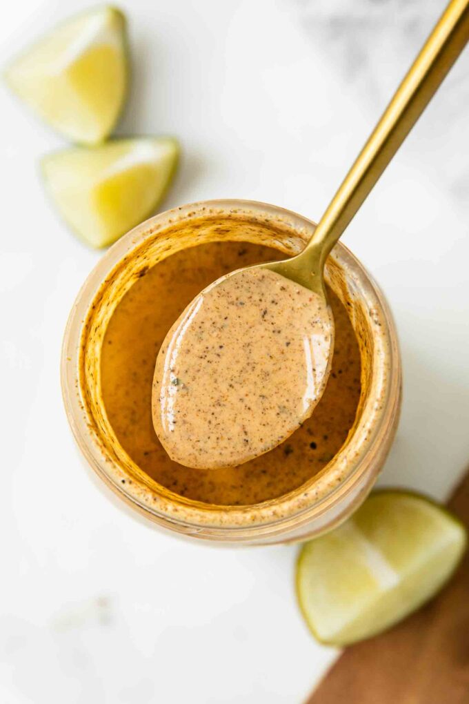 Top shot of southwest salad dressing in a jar with a spoon.
