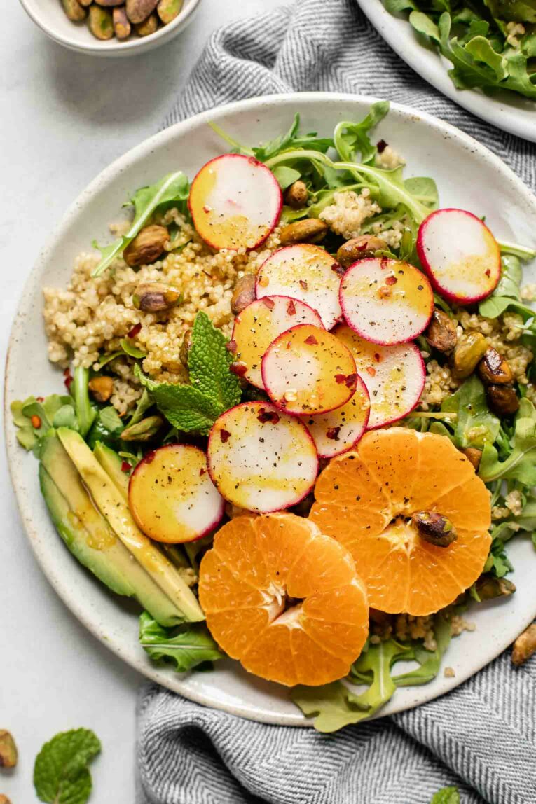 Spicy Radish Summer Quinoa Salad on a white plate with a napkin.