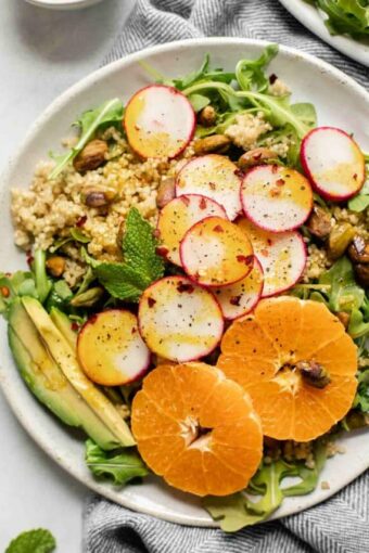 Spicy Radish Summer Quinoa Salad on a white plate with a napkin.