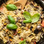 Lemon Garlic Eggplant Mushroom Orzo in a skillet with fresh basil.