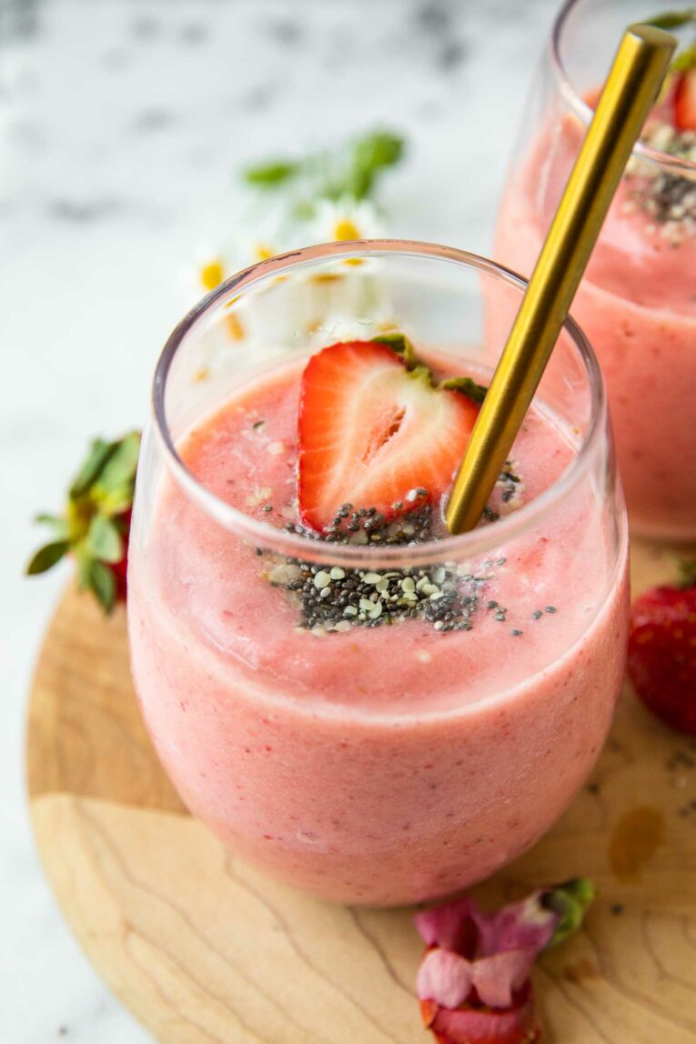 Angled shot of Strawberry Pineapple Smoothie in a glass cup.