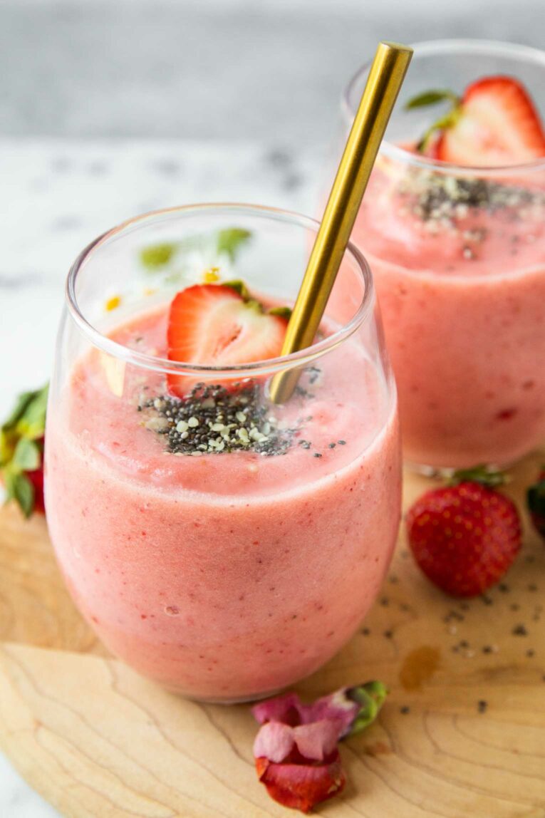 Close up of Strawberry Pineapple Smoothie in a glass cup.