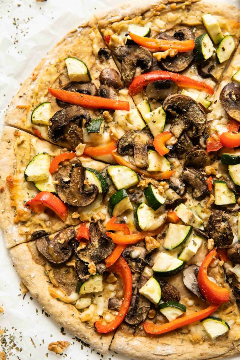 Top shot of freshly baked vegan hummus pizza.