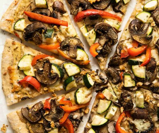 Vegan Hummus pizza with mushrooms, zucchini, and red peppers.