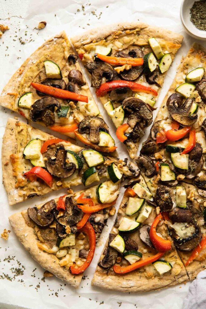 Vegan Hummus pizza with mushrooms, zucchini, and red peppers.
