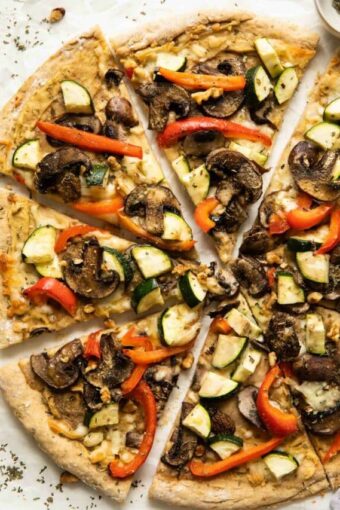 Vegan Hummus pizza with mushrooms, zucchini, and red peppers.