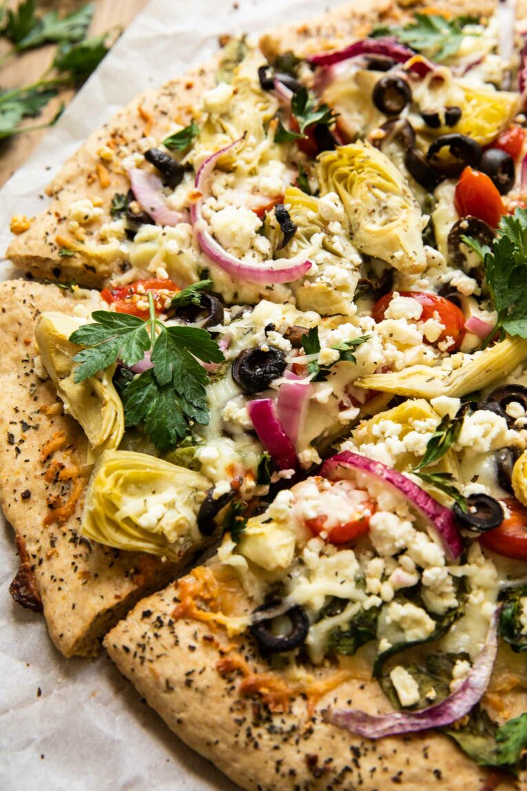 Angled shot of Mediterranean pizza.