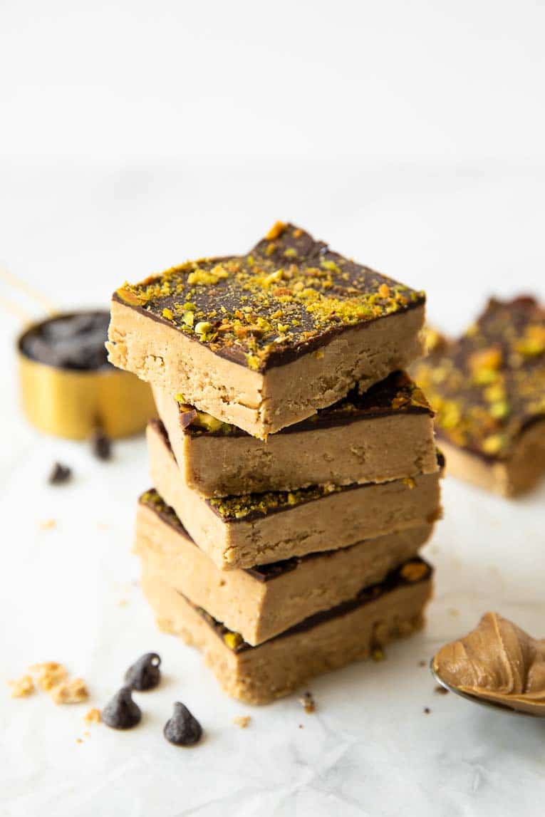 Stacked homemade protein bars on parchment paper.