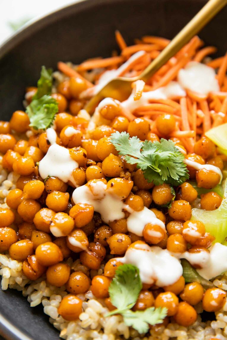 Angled close up of hot honey chickpeas in a bowl with cilantro.