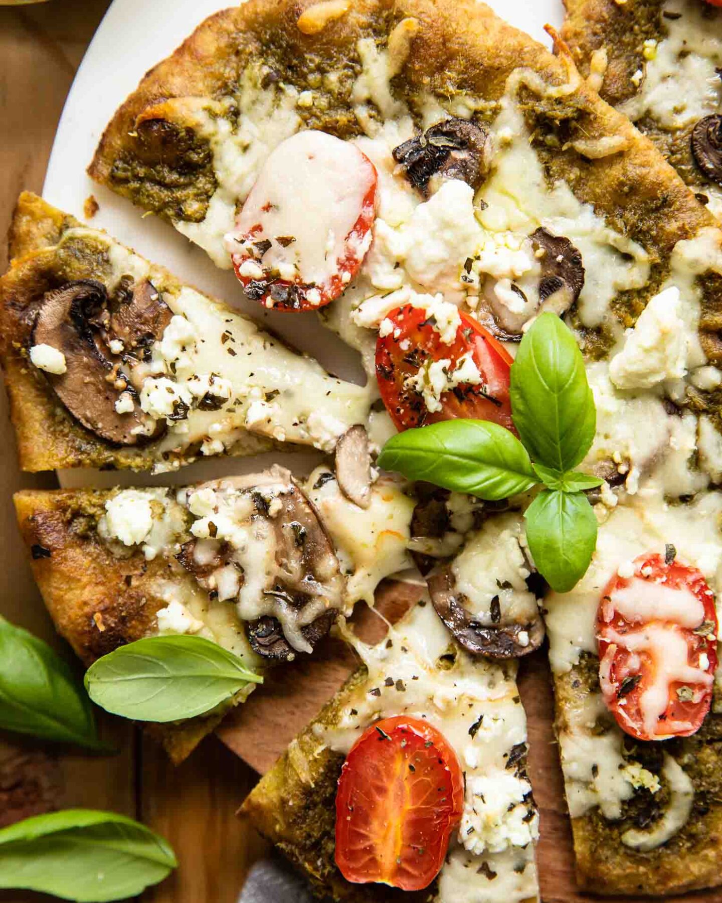 Top shot of Spinach Pesto Goat Cheese Individual Pizza.