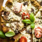 Top shot of Spinach Pesto Goat Cheese Individual Pizza.