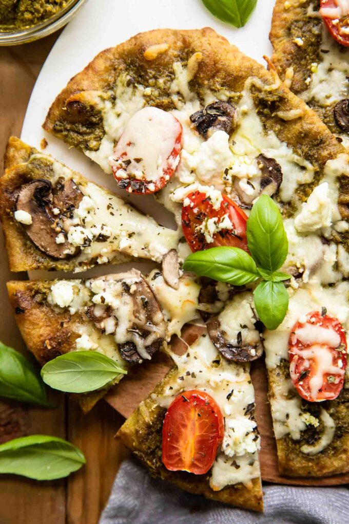 Top shot of Spinach Pesto Goat Cheese Individual Pizza.