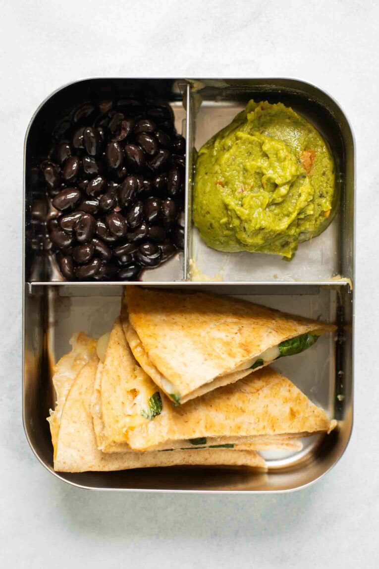 Top shot of quesadilla, guacamole, and beans.