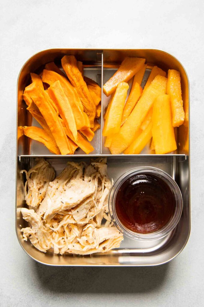 Shredded chicken with barbecue sauce, sweet potato fries, and peaches.