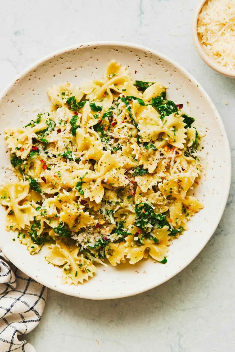 Creamy kale pasta recipe on a plate with parmesan.