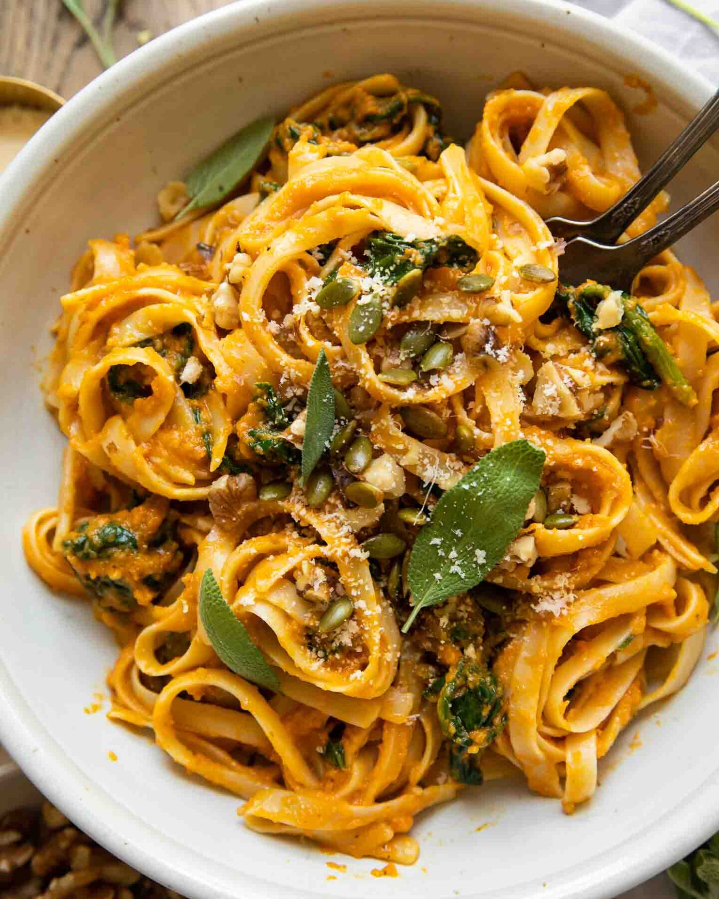 Top shot of Creamy Pumpkin Sage Pasta with forks in a bowl.