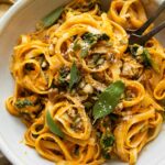 Top shot of Creamy Pumpkin Sage Pasta with forks in a bowl.