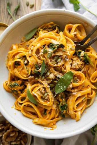 Top shot of Creamy Pumpkin Sage Pasta with forks in a bowl.