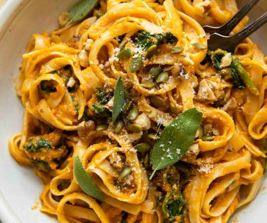 Top shot of Creamy Pumpkin Sage Pasta with forks in a bowl.