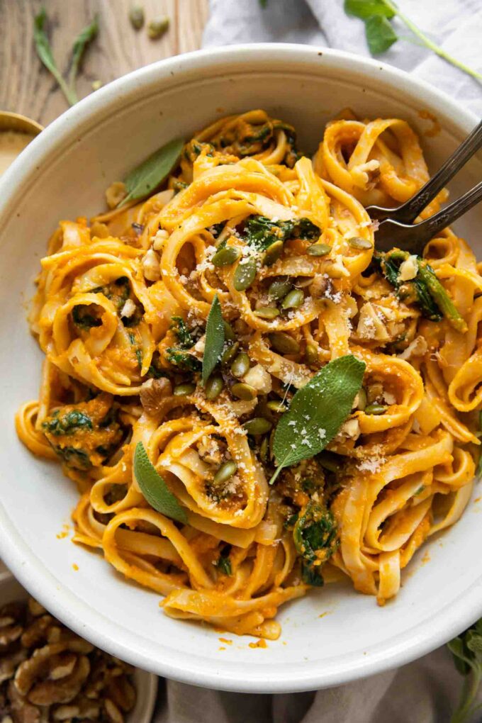 Top shot of Creamy Pumpkin Sage Pasta with forks in a bowl.