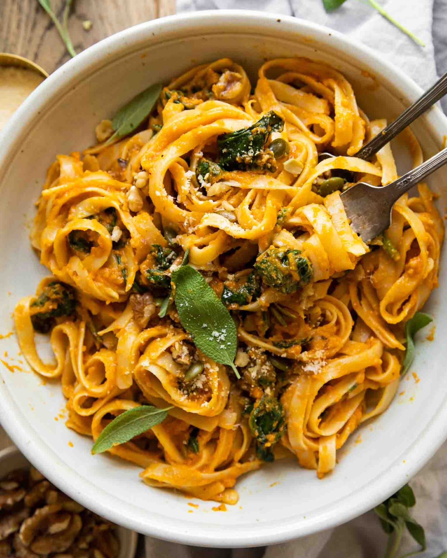 Creamy Pumpkin Pasta in a white bowl with forks.