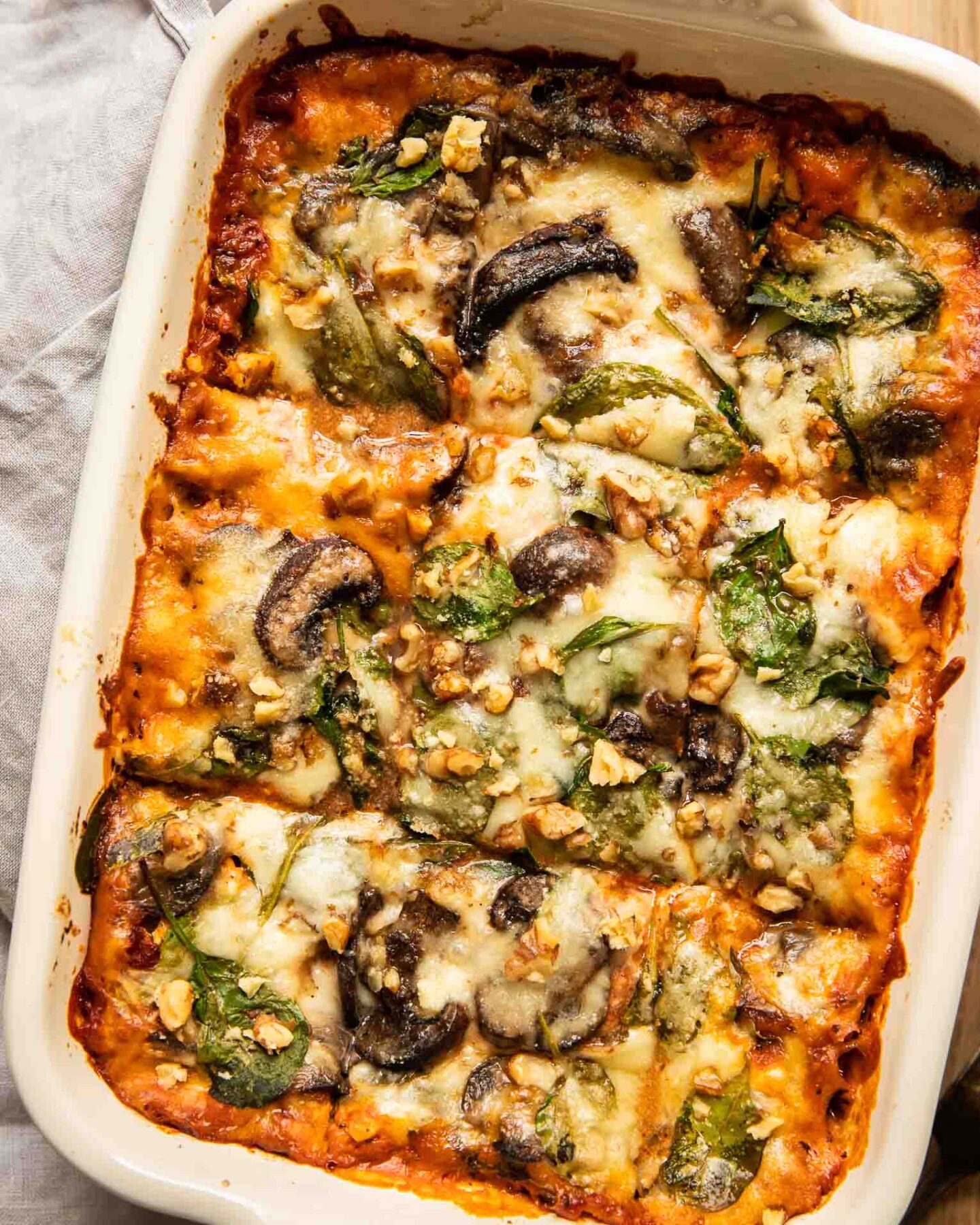 Top shot of vegetarian lasagna with spinach and mushrooms.