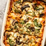 Top shot of vegetarian lasagna with spinach and mushrooms.
