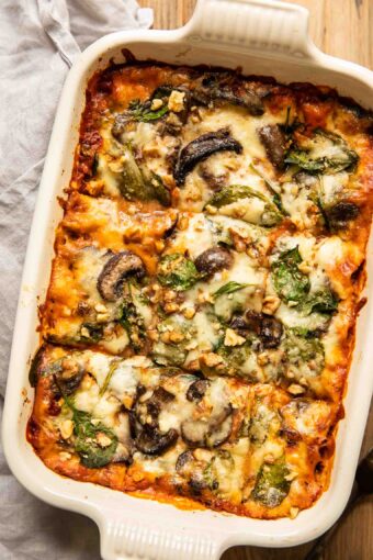 Top shot of vegetarian lasagna with spinach and mushrooms.