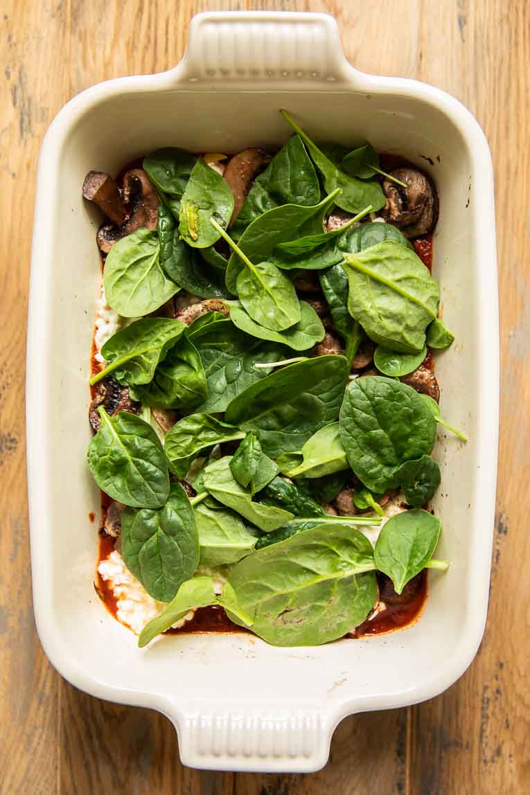 Spinach and cooked mushrooms in lasagna.