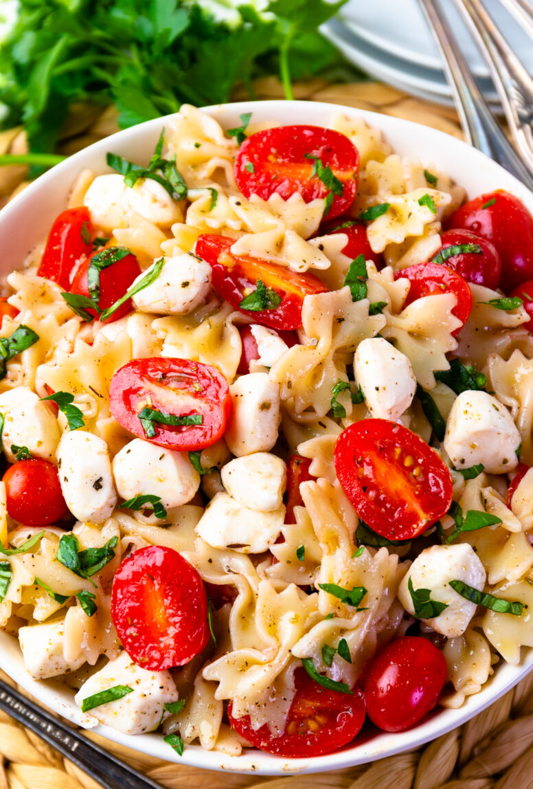 Healthy Caprese Pasta Salad in a white bowl.