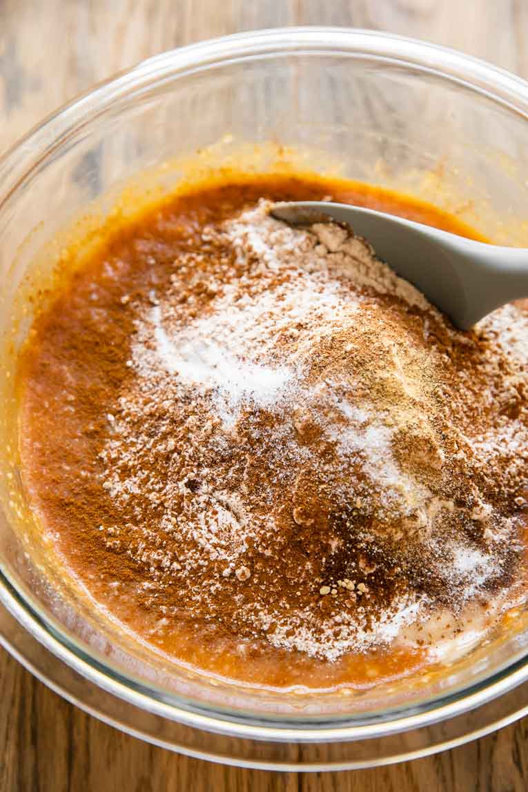 Dry ingredients being added to liquid ingredients for pumpkin bread.