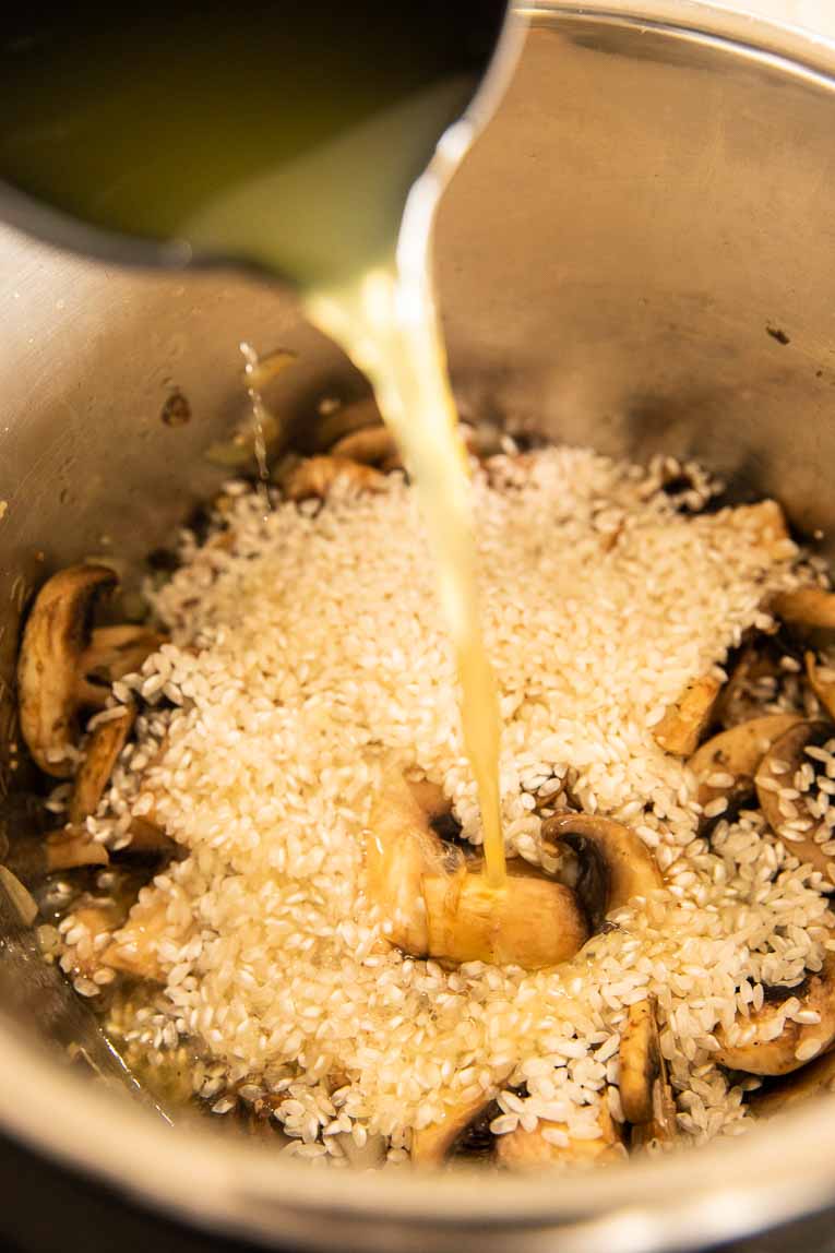 Broth being poured over rice in an Instant Pot.