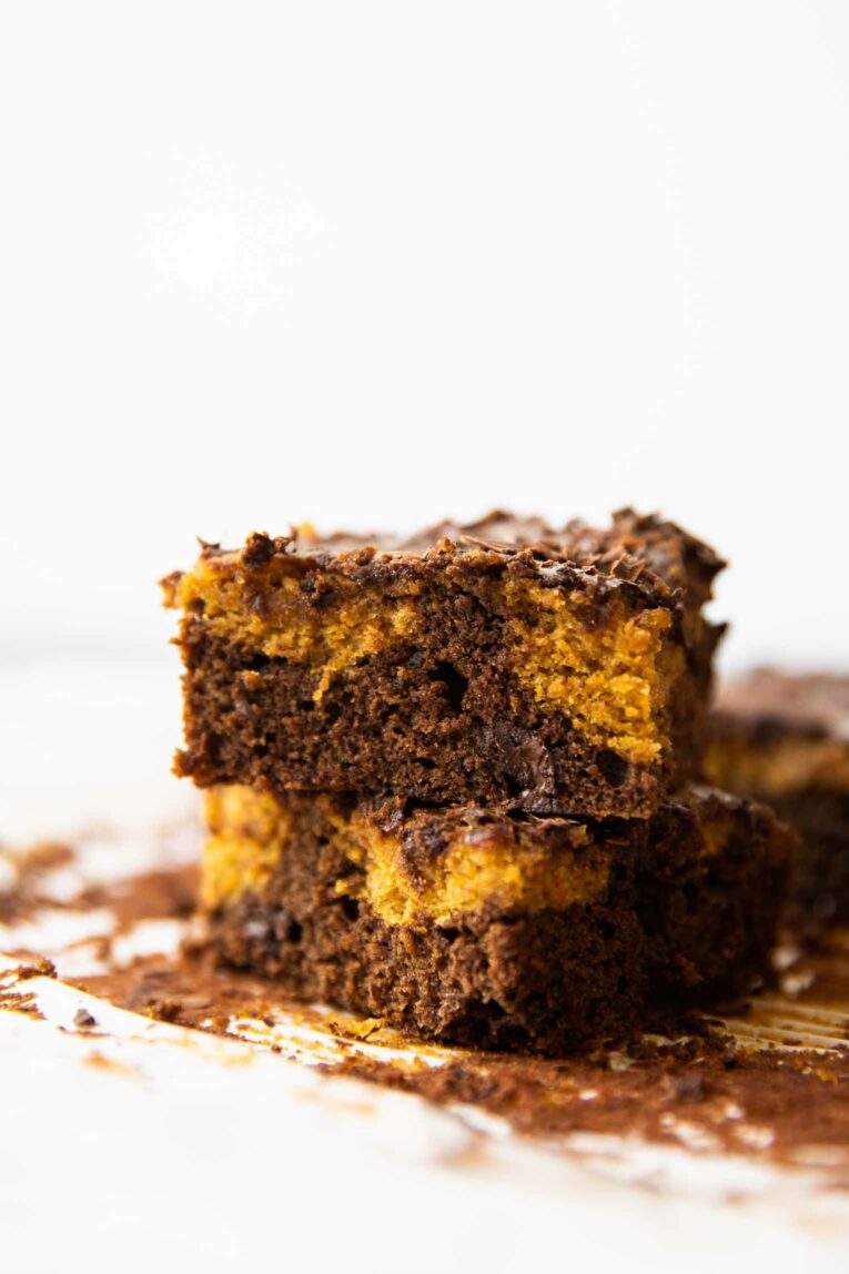 Across shot of pumpkin brownies, featuring layers of chocolate and pumpkin.