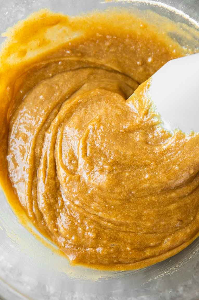 Vanilla brownies batter being mixed in a glass bowl.