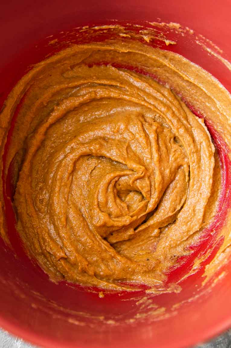 Pumpkin brownie batter being mixed in a mixing bowl.