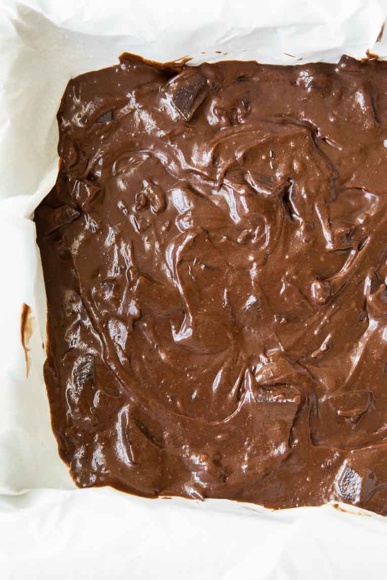 Layer of chocolate brownie in a baking pan.