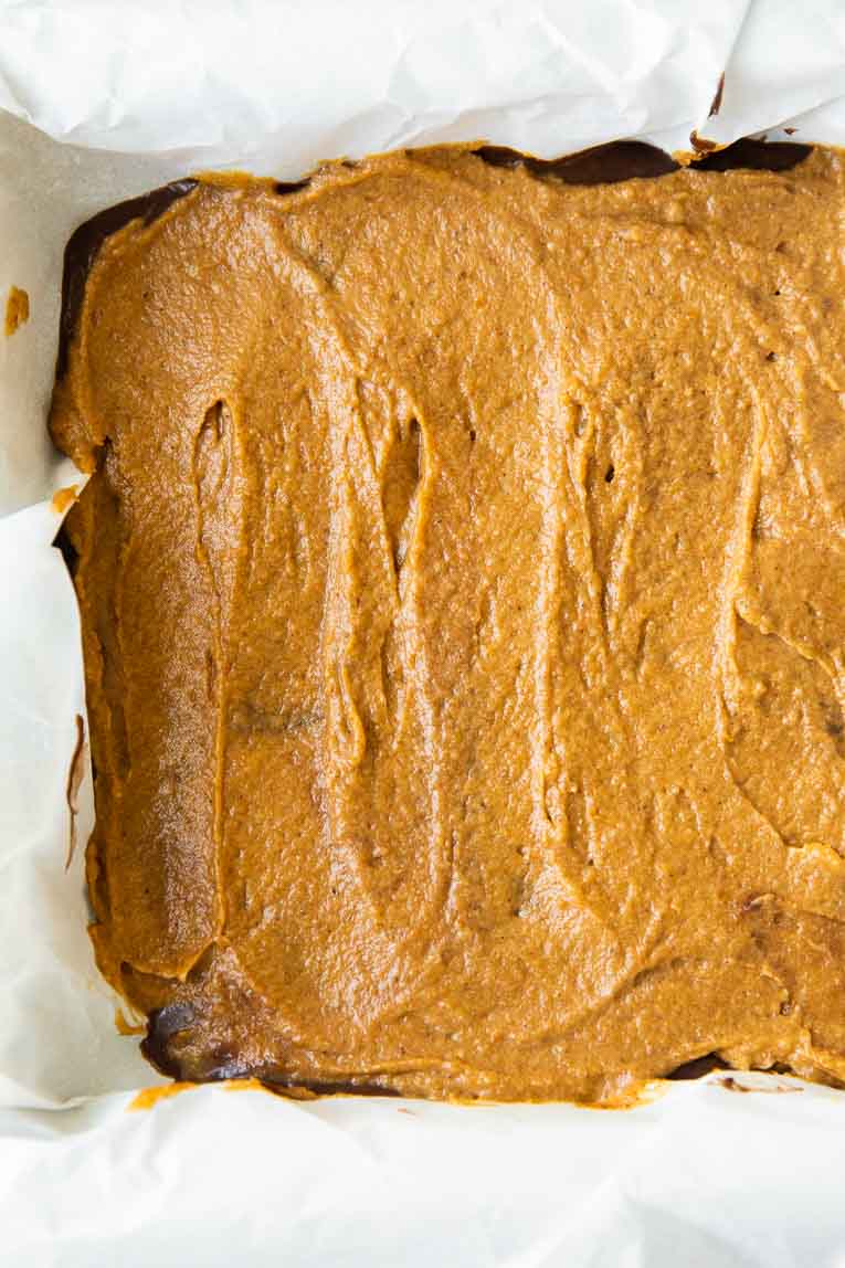 Layer of pumpkin brownie batter in a baking pan.