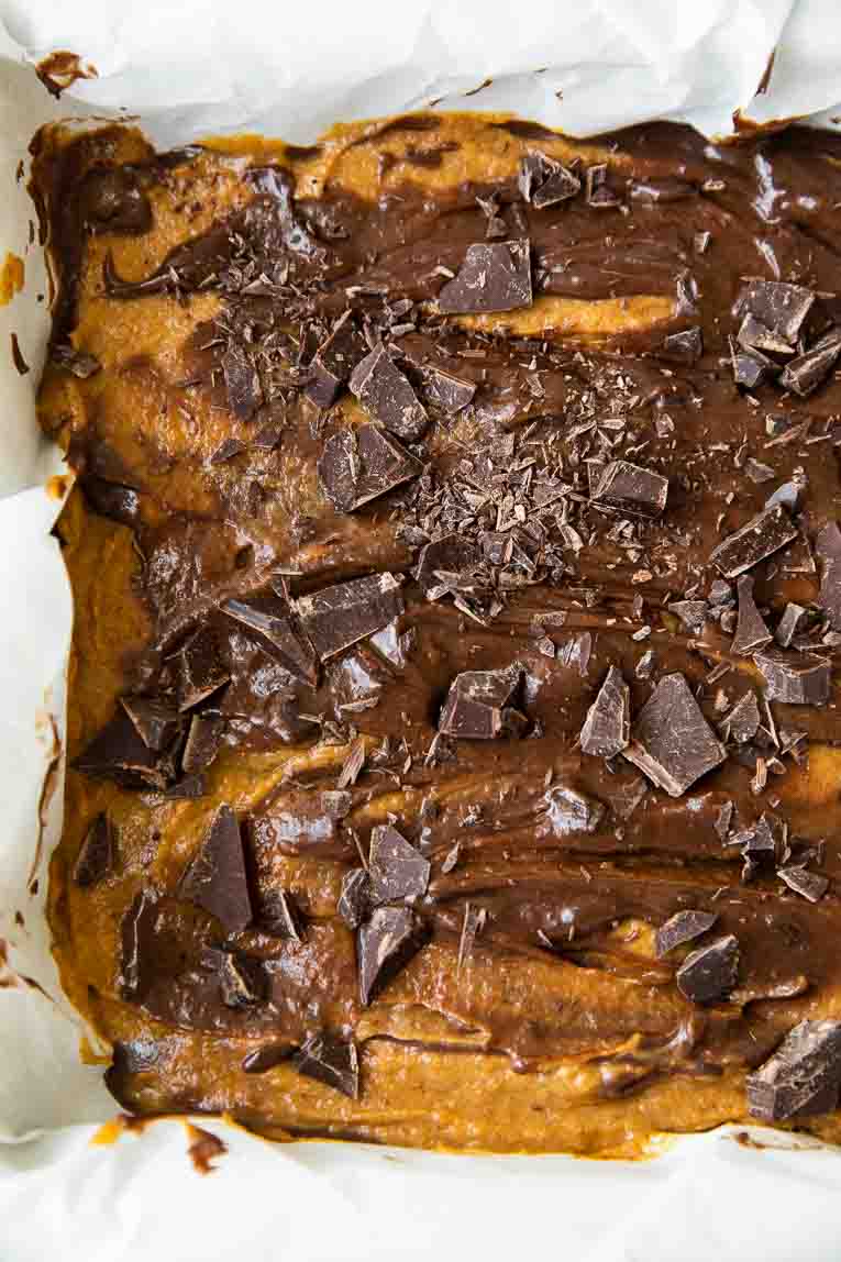 Marbled chocolate and pumpkin brownie batter in a baking pan.