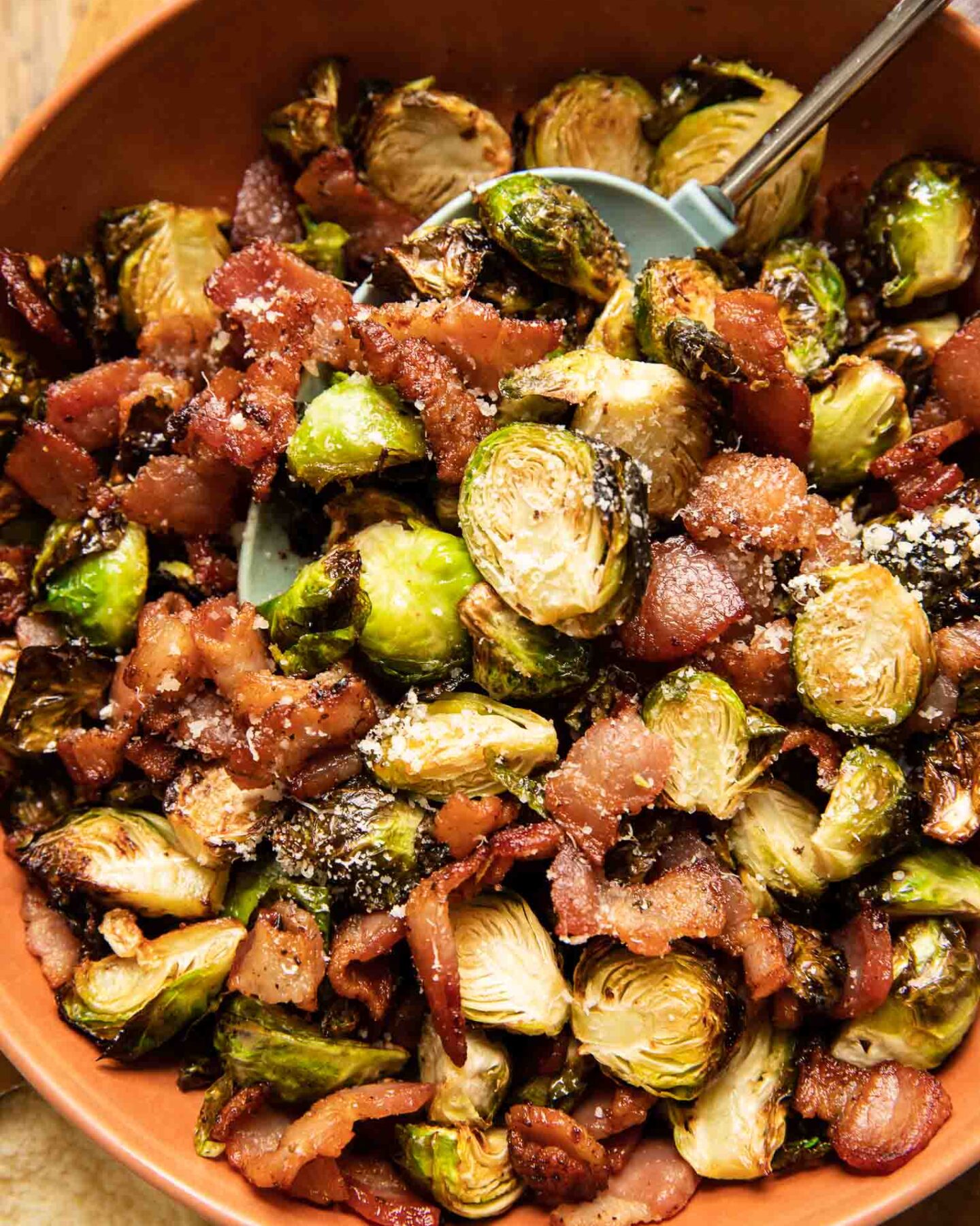 Air fryer brussels sprouts and bacon with parmesan in a bowl.