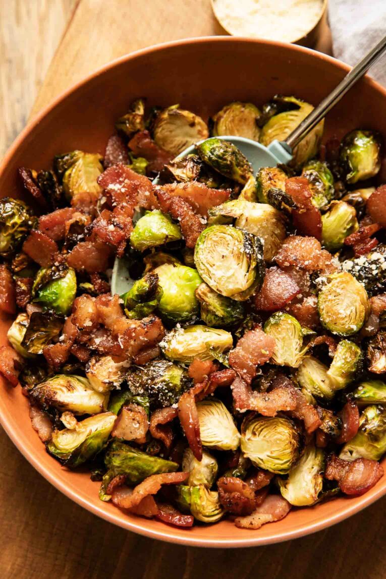 Air Fried Brussels Sprouts with bacon, garlic, and parmesan in a serving bowl.