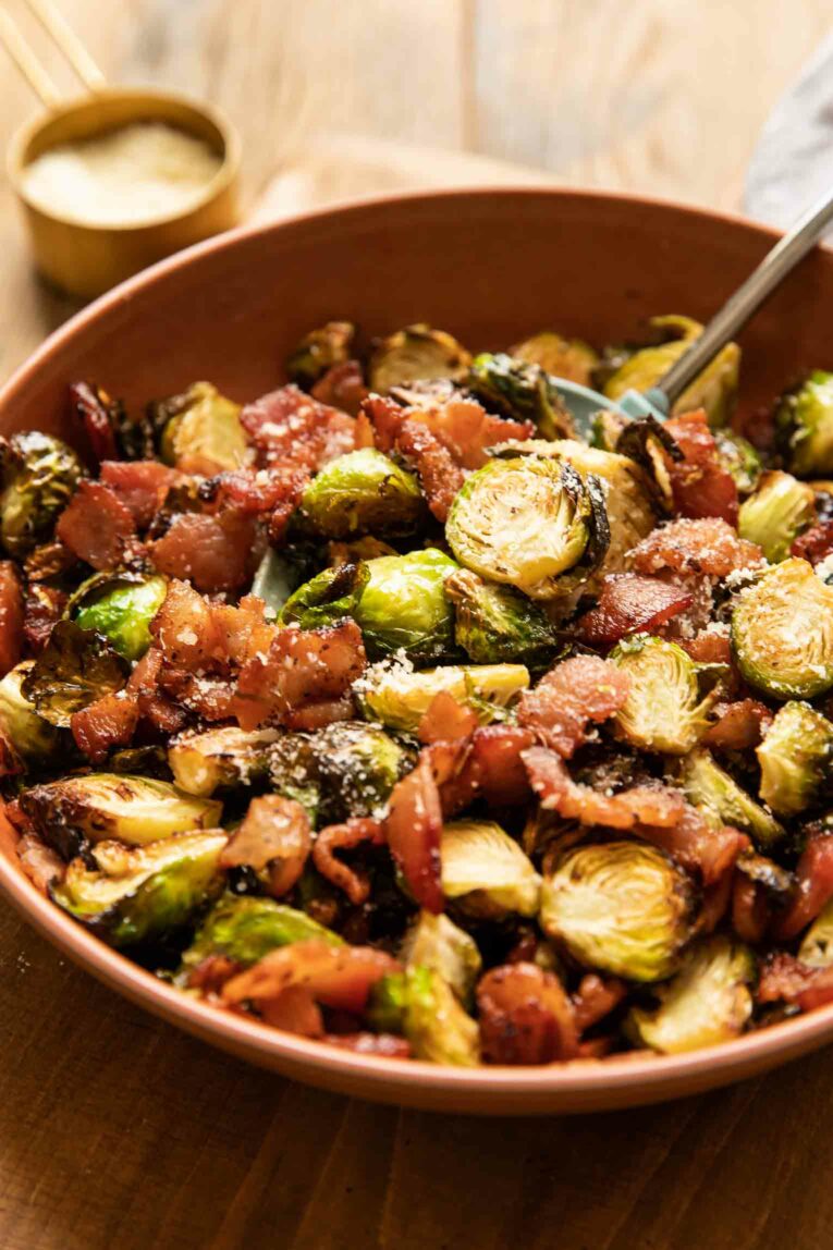 Angled shot of crispy air fryer brussels sprouts and bacon.