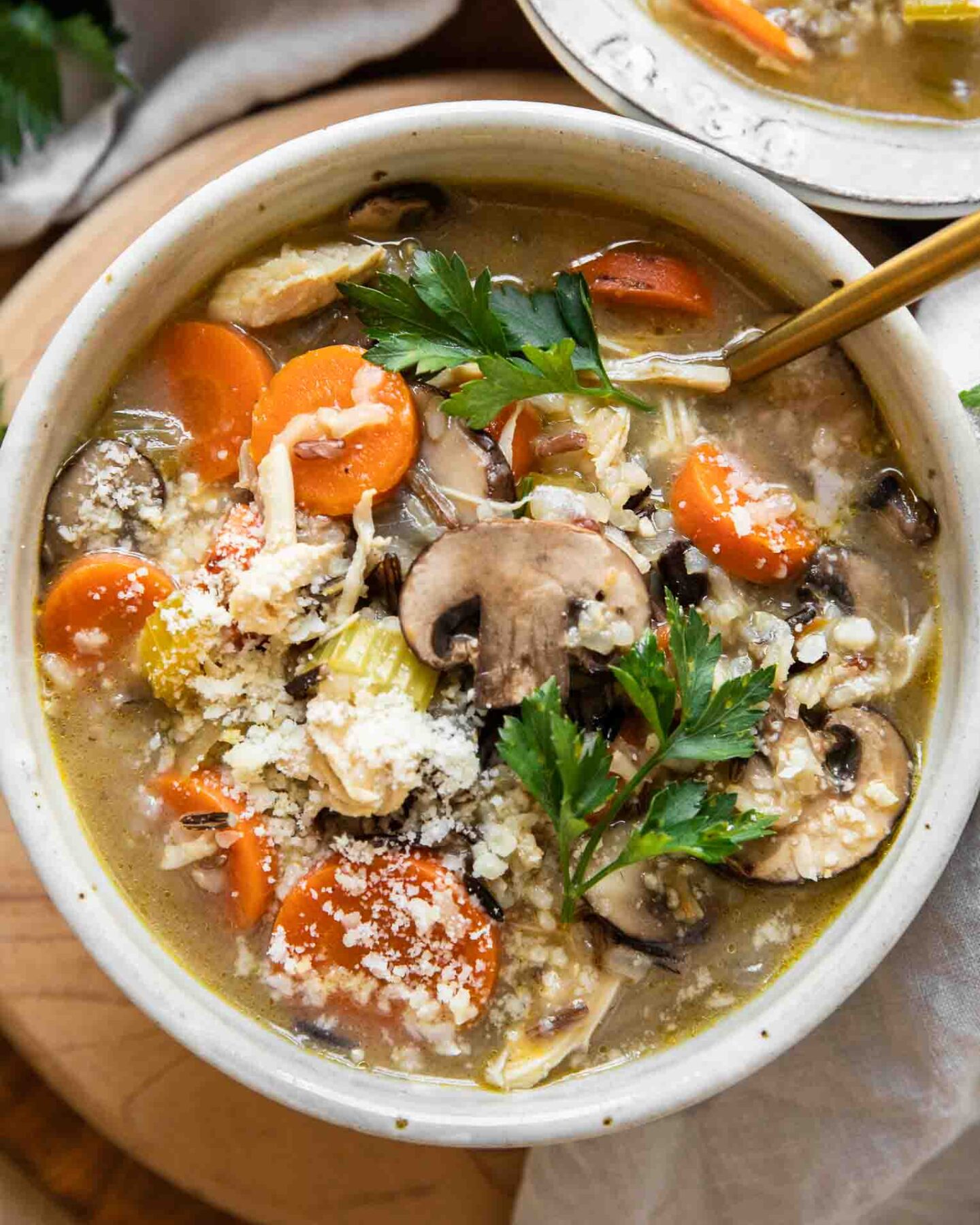 Creamy Turkey Wild Rice Soup in a white bowl with a spoon.